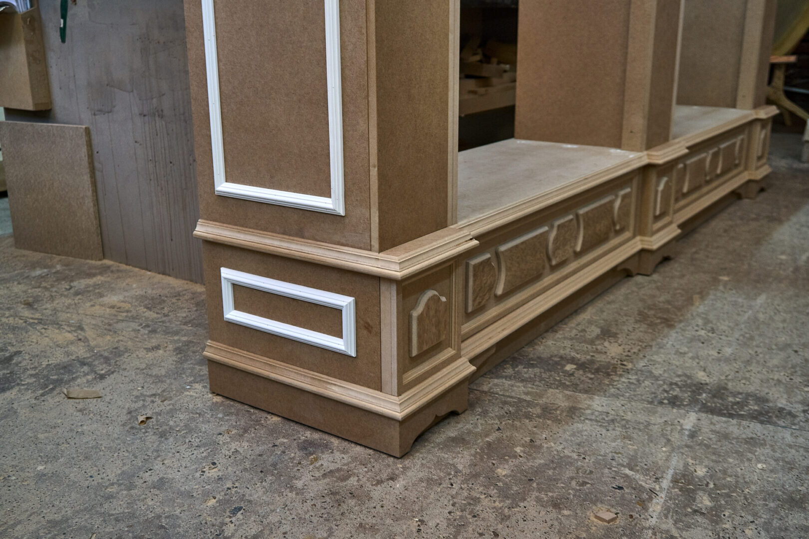 Wooden furniture base with decorative trim