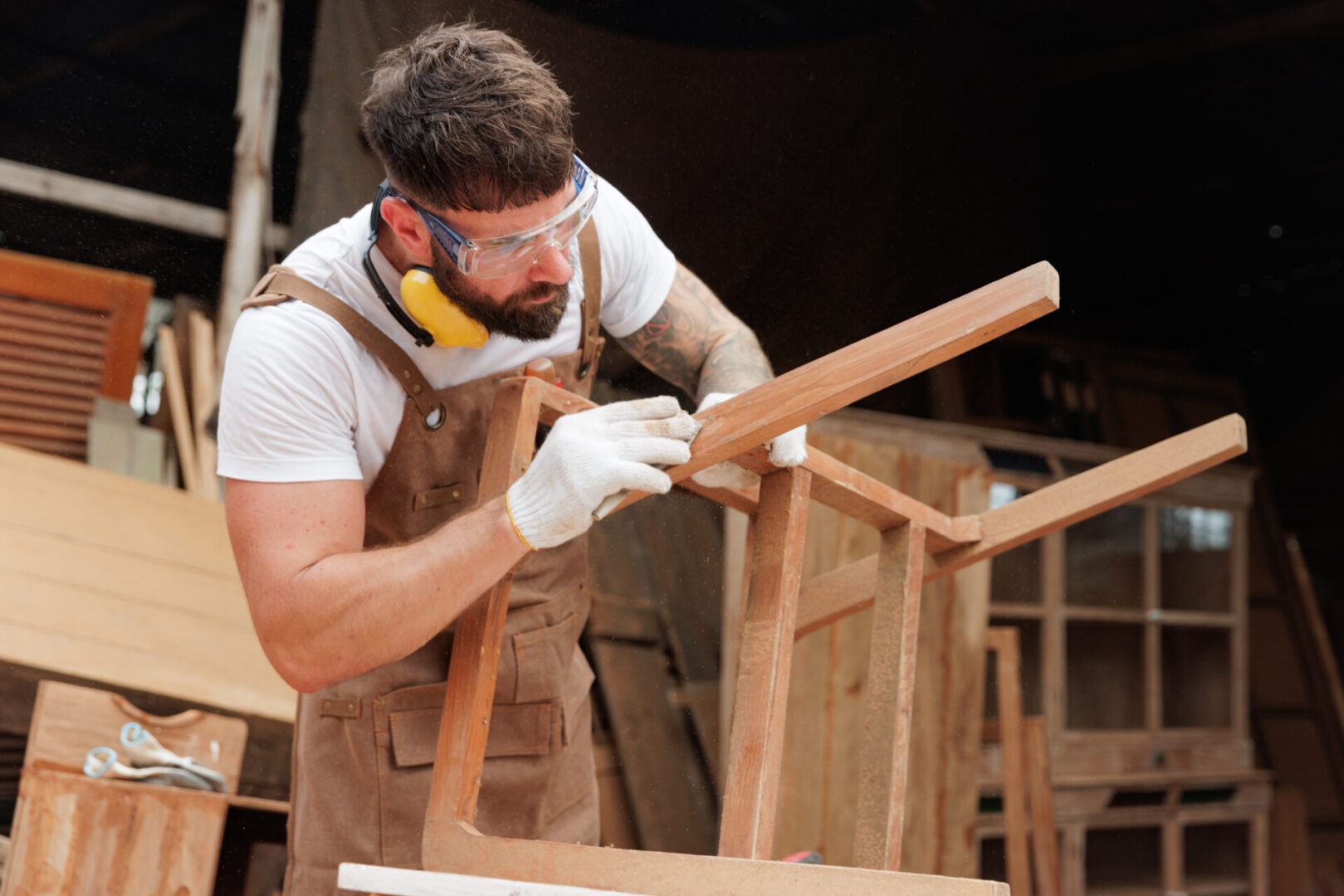 Man finishing a wooden chair project