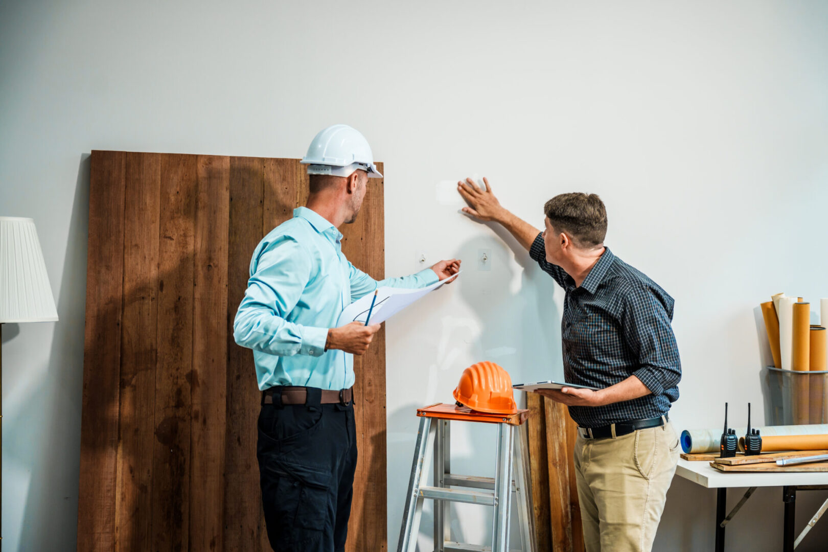 Architects reviewing wall plans together