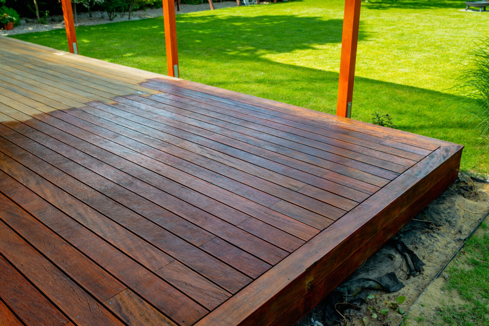 Wet wooden deck drying in sunlight