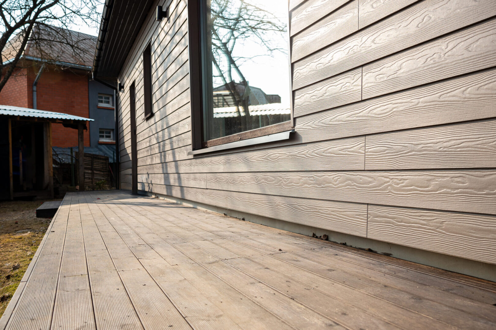 Sunlit wooden porch by house