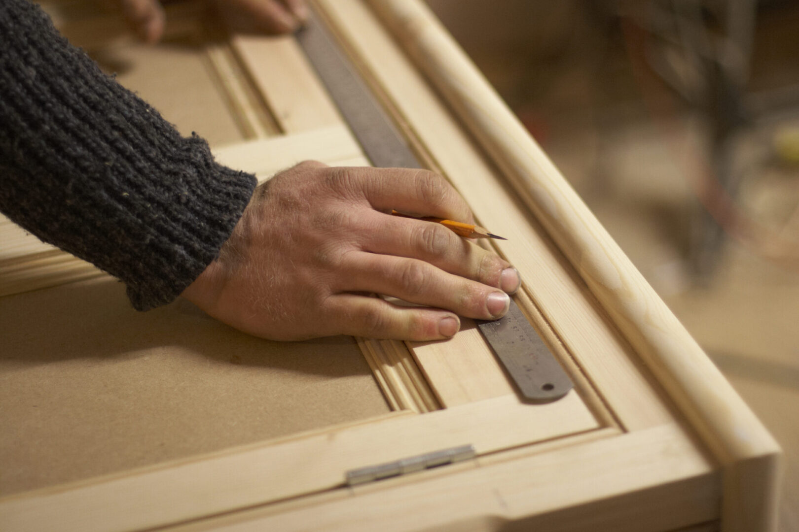 Carpenter measuring wood with a ruler