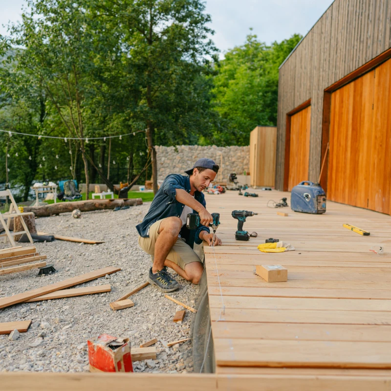 Man working on outdoor wooden deck